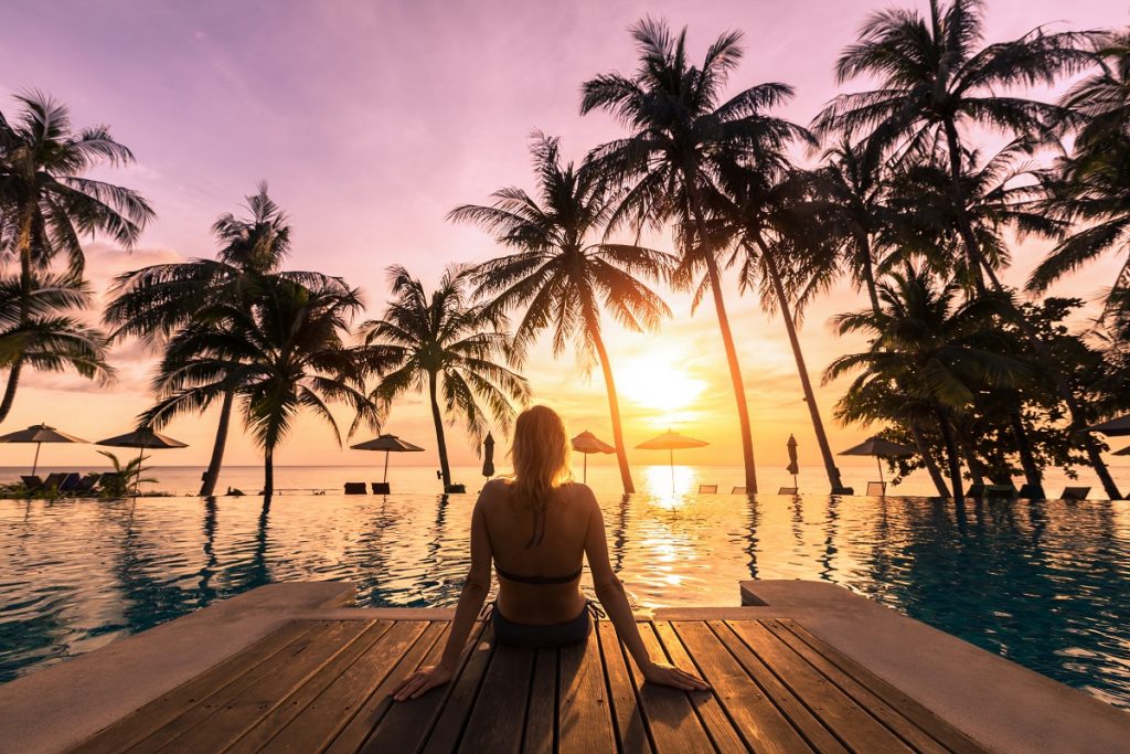 Woman enjoying the sunset near the ocean