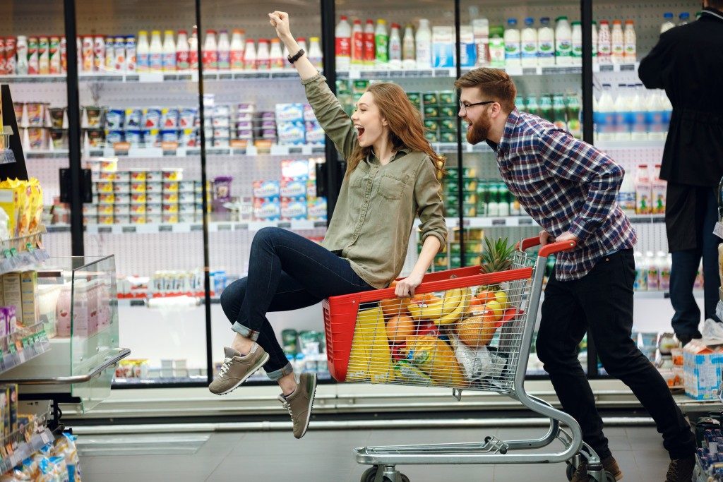 couple playing around at grocery store