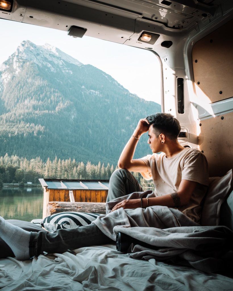 man sitting at the back of a van