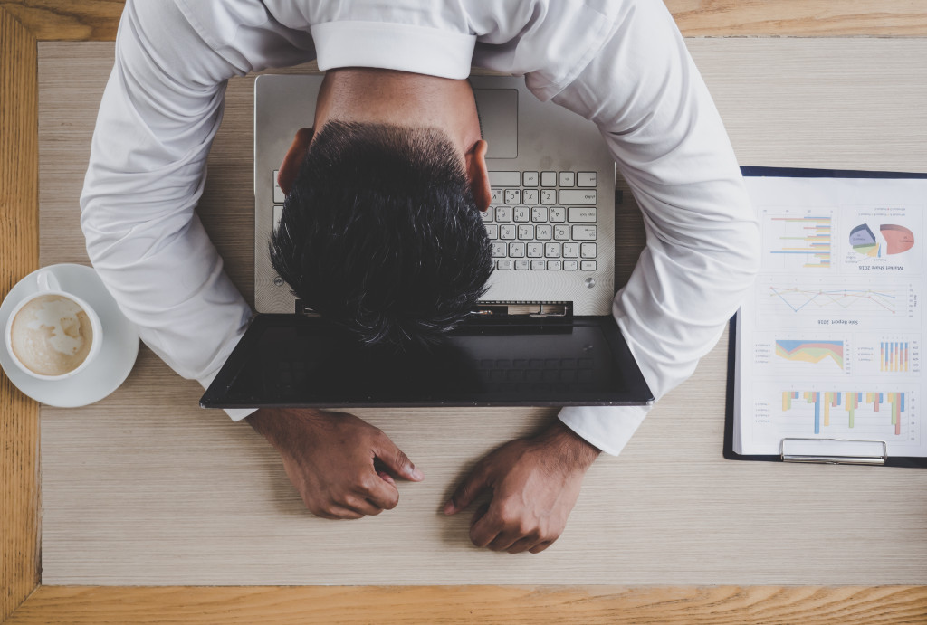 man sleeping on laptop